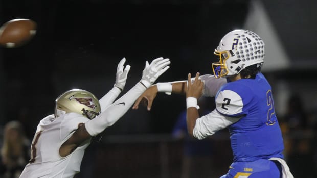 Gahanna's Brennen Ward just gets rid of the ball before being hit by New Albany's Chidi Mabatah during their game at Whitehall Yearling High School on Sept. 30.